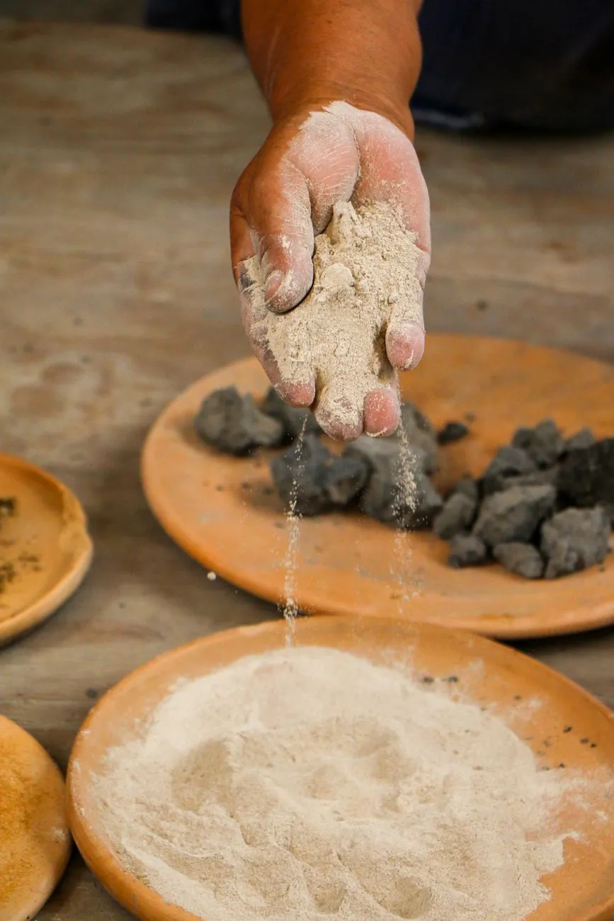 Canihua grains being sifted in a traditional wooden bowl