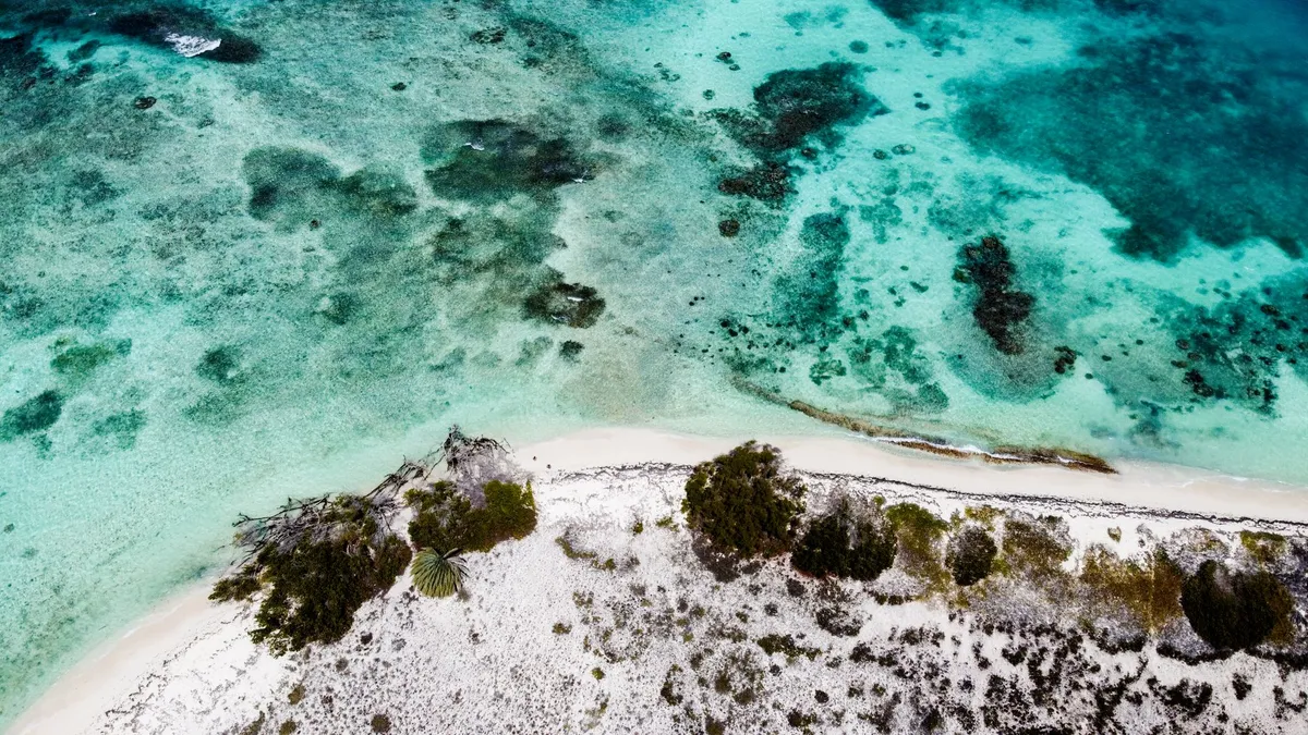 Aerial view of Antigua's turquoise waters and white-sand beaches