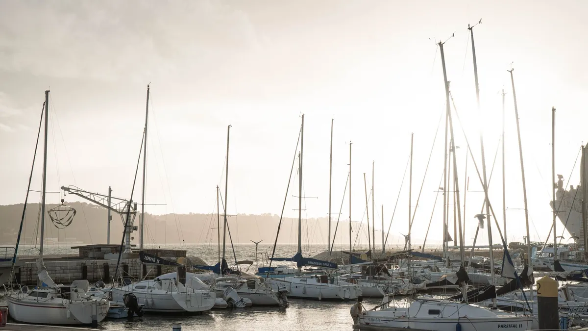 Sunset over Antigua's English Harbour with sailboats in the distance
