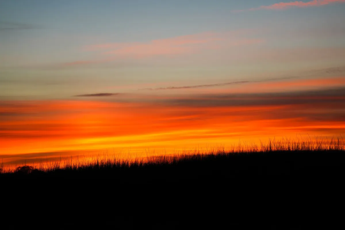 Uluru at sunset with vibrant red hues
