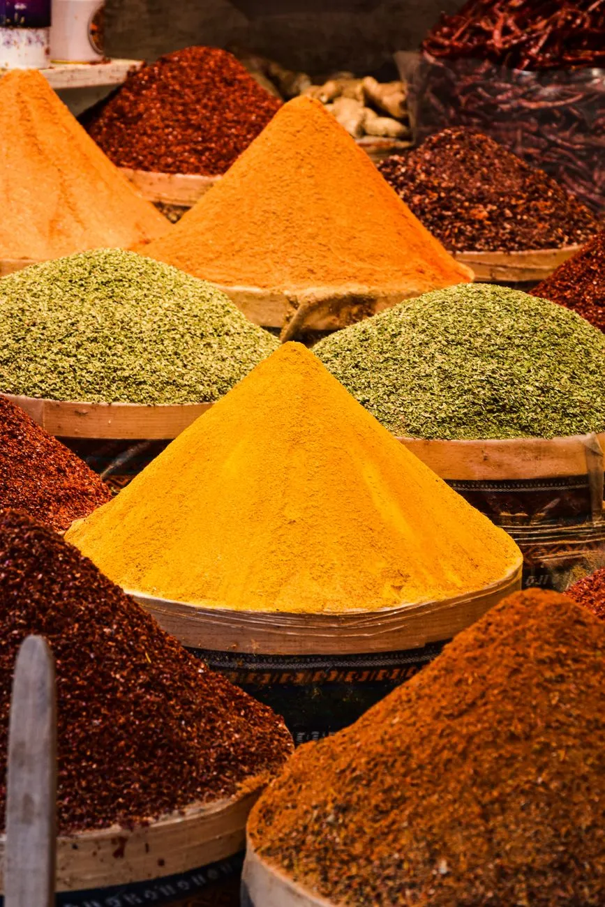 A close-up of traditional Awadhi spices like saffron, cardamom, and mace