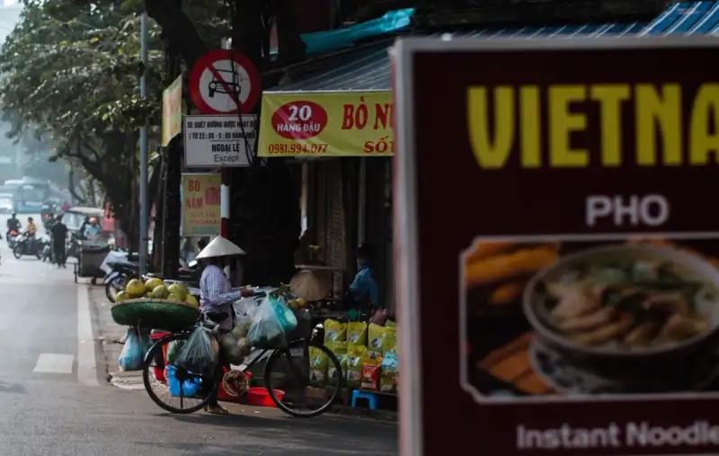 Street vendors preparing Banh Mi in Hanoi