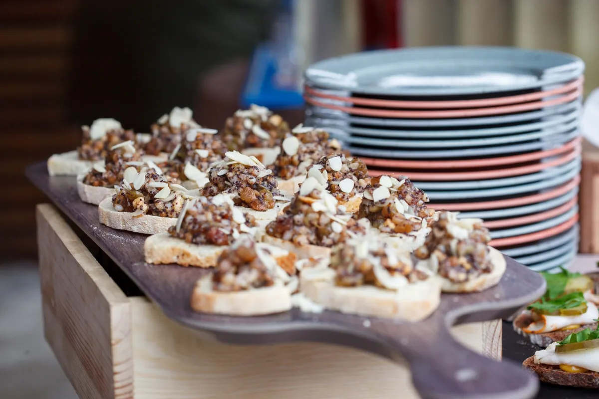 A vibrant spread of Basque pintxos on a wooden bar counter