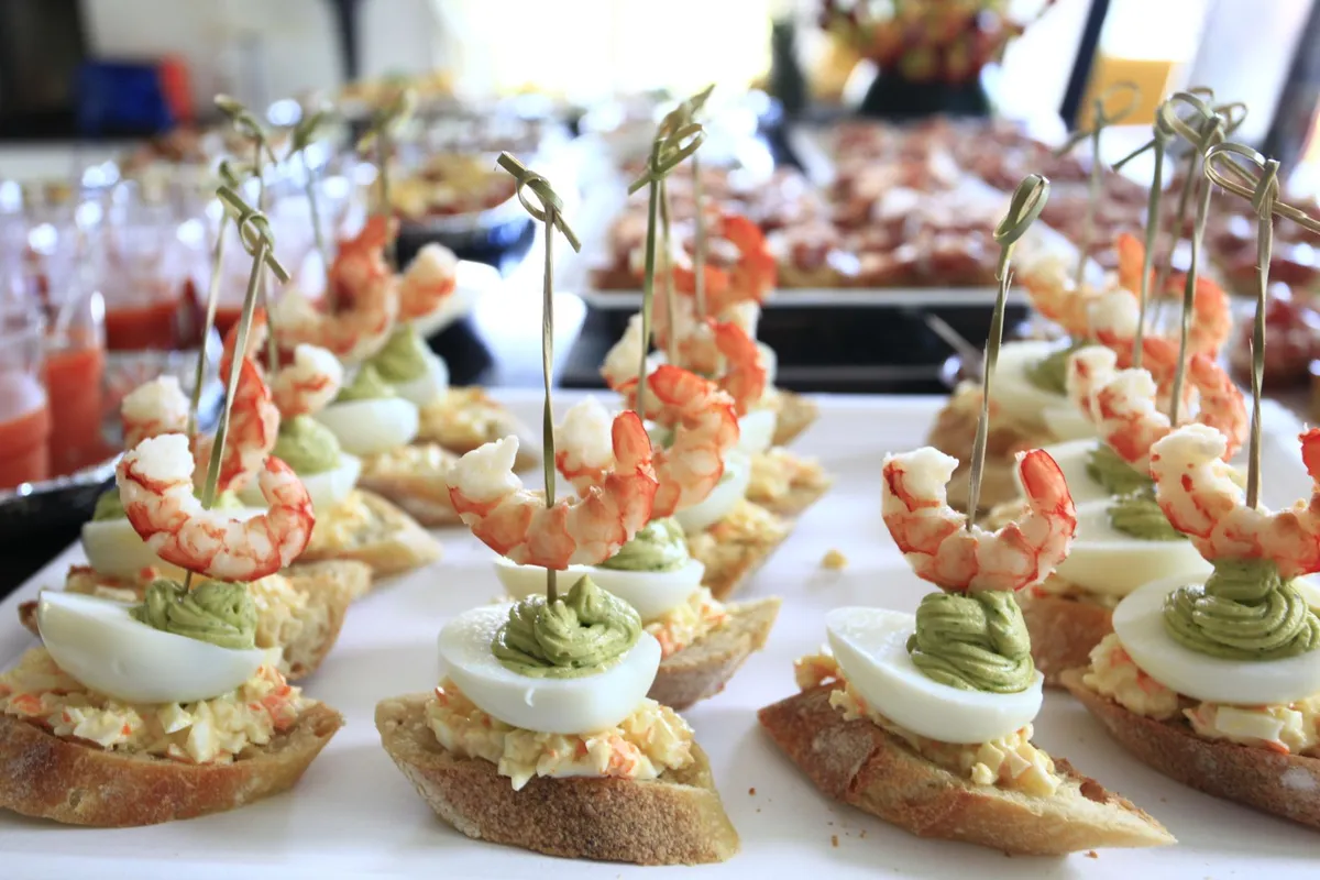 A close-up of a traditional Gilda pintxo with anchovy, olive, and guindilla pepper