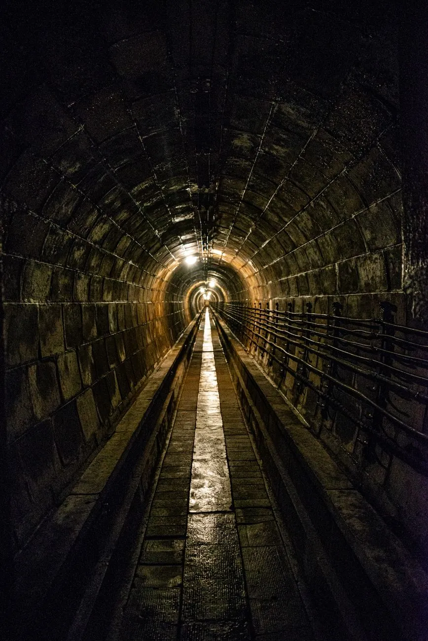 Narrow stone corridor deep within the historical Parisian quarries