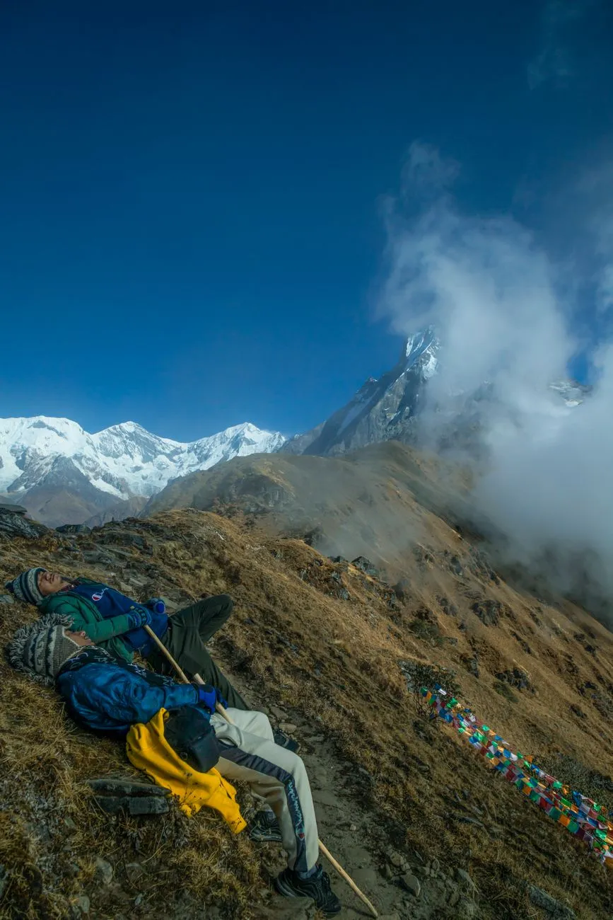 A group of international travelers resting on the Tiger’s Nest trail, sharing stories and laughter