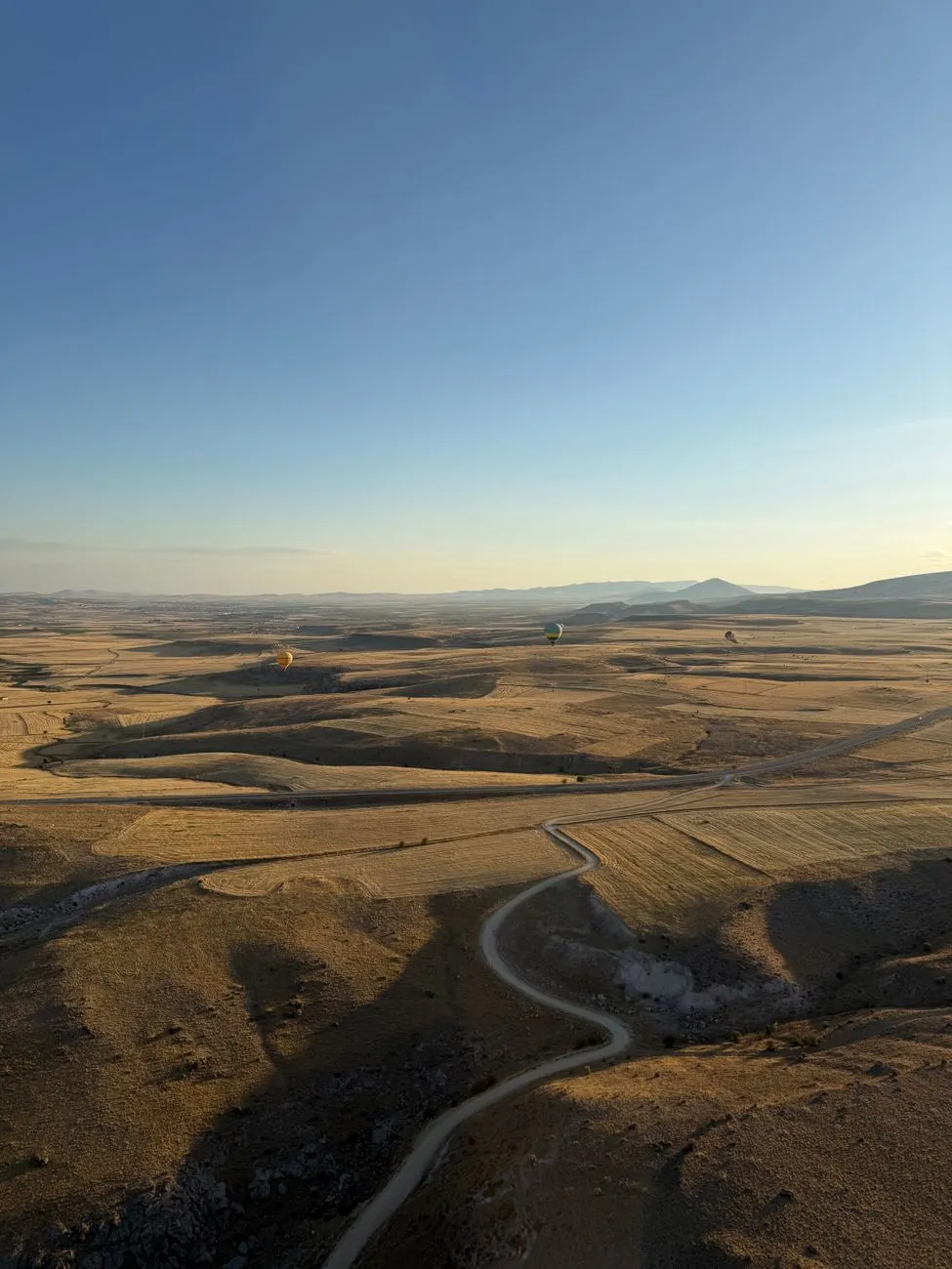 Hot air balloons floating over Cappadocia's fairy chimneys at sunrise