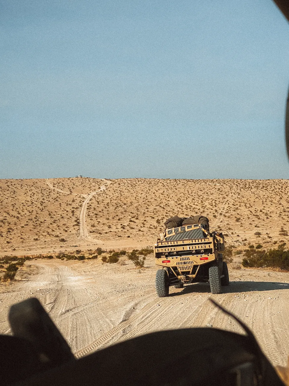 Remote desert landscape with a lone 4x4 vehicle and starry sky