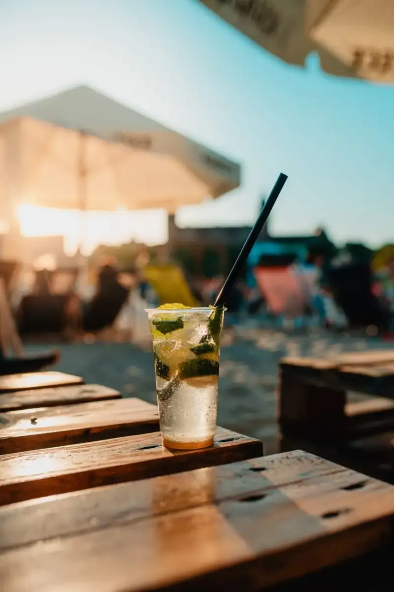 Mojito served in a tropical setting with palm trees