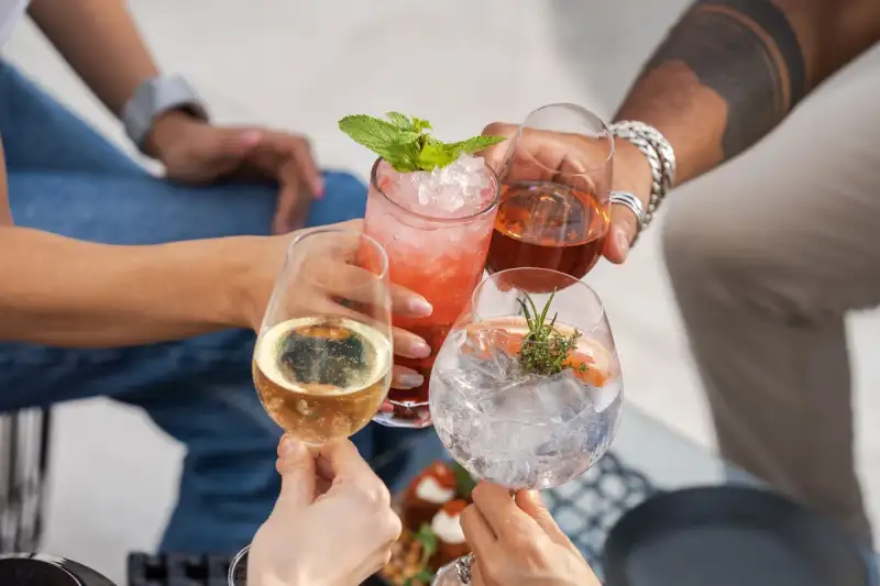 Group of friends toasting with mojitos