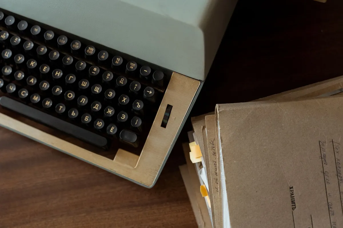 An old typewriter with a blank sheet of paper