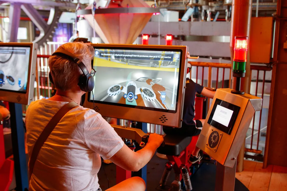Futuristic manufacturing floor with holographic displays showing digital twin interfaces