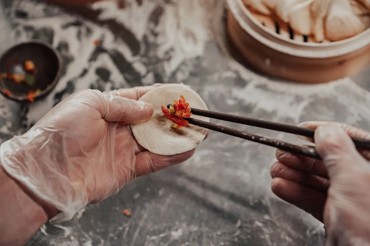 A close-up of a steaming har gow dumpling