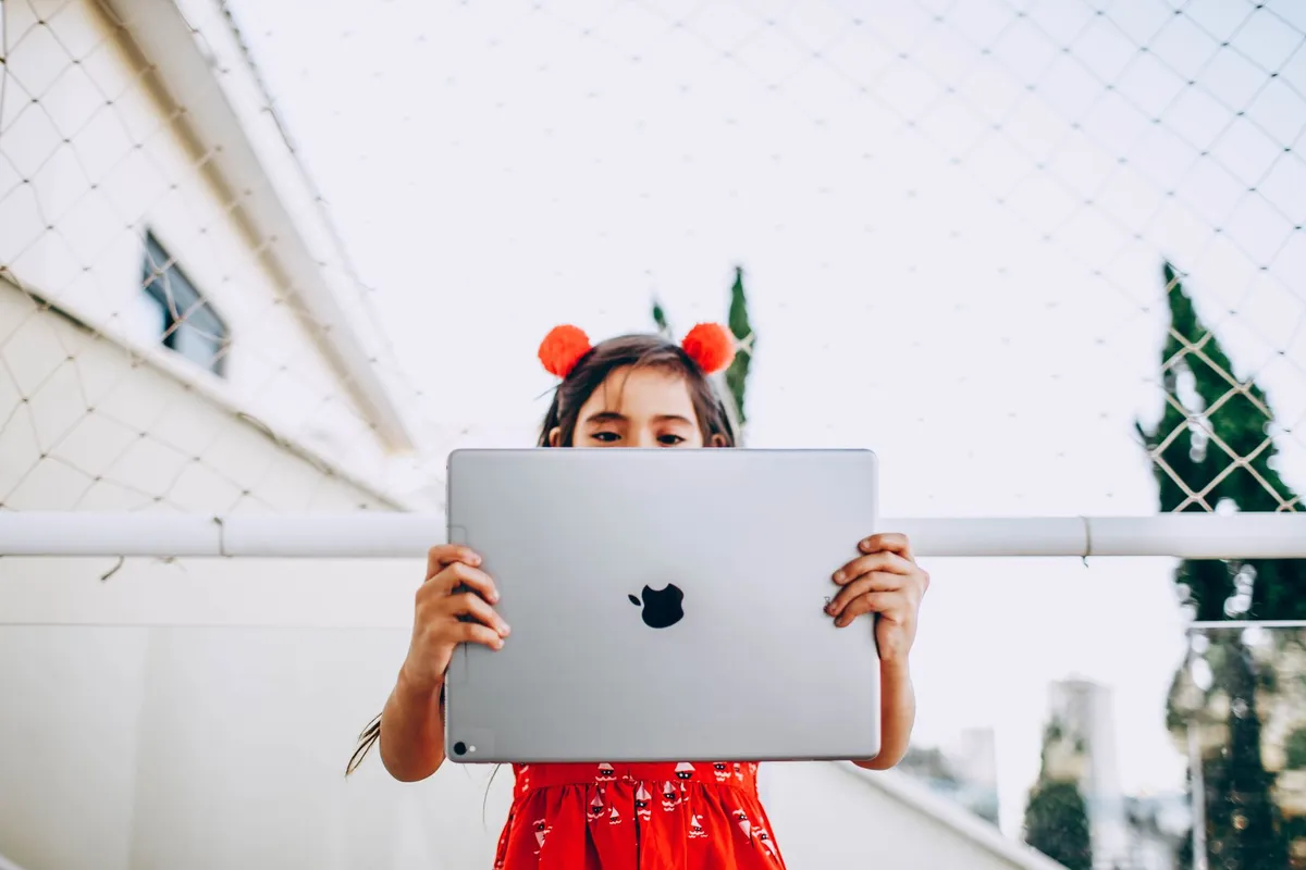 Child using a tablet with edge AI app in a rural setting