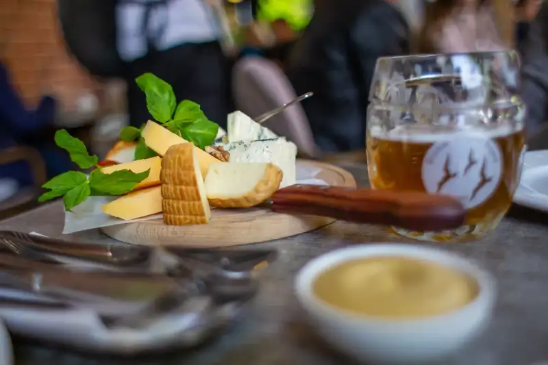 A flight of craft beers paired with aged cheddar and Gouda