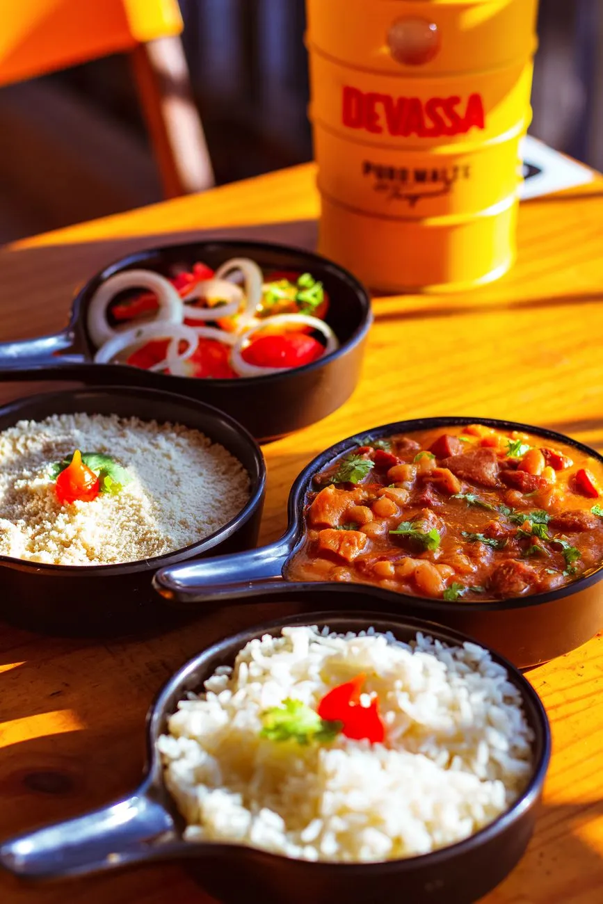 Serving traditional Brazilian feijoada with sides