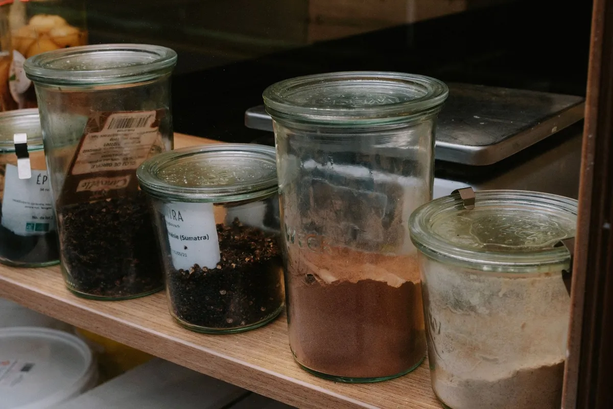Glass jars of kombucha brewing on a kitchen counter