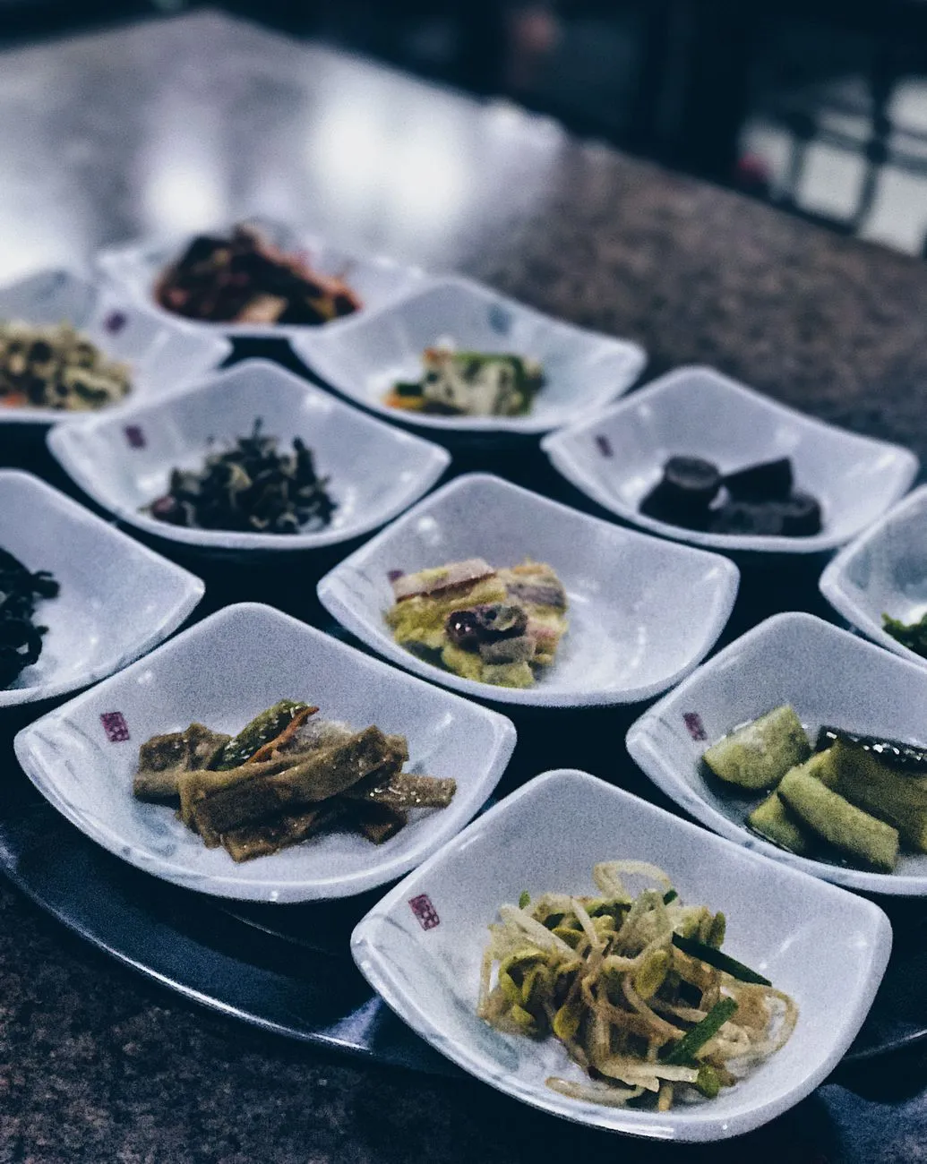 A traditional Korean table setting with a variety of kimchi dishes
