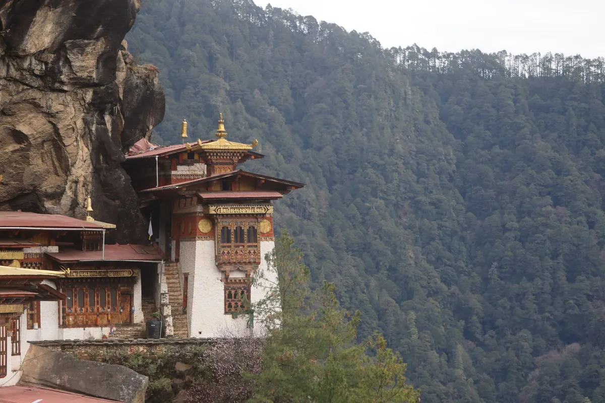 A serene view of the monastery clinging to the sheer mountain cliffside