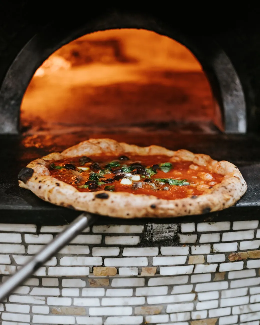Image of a traditional Neapolitan pizzeria with a wood-fired oven