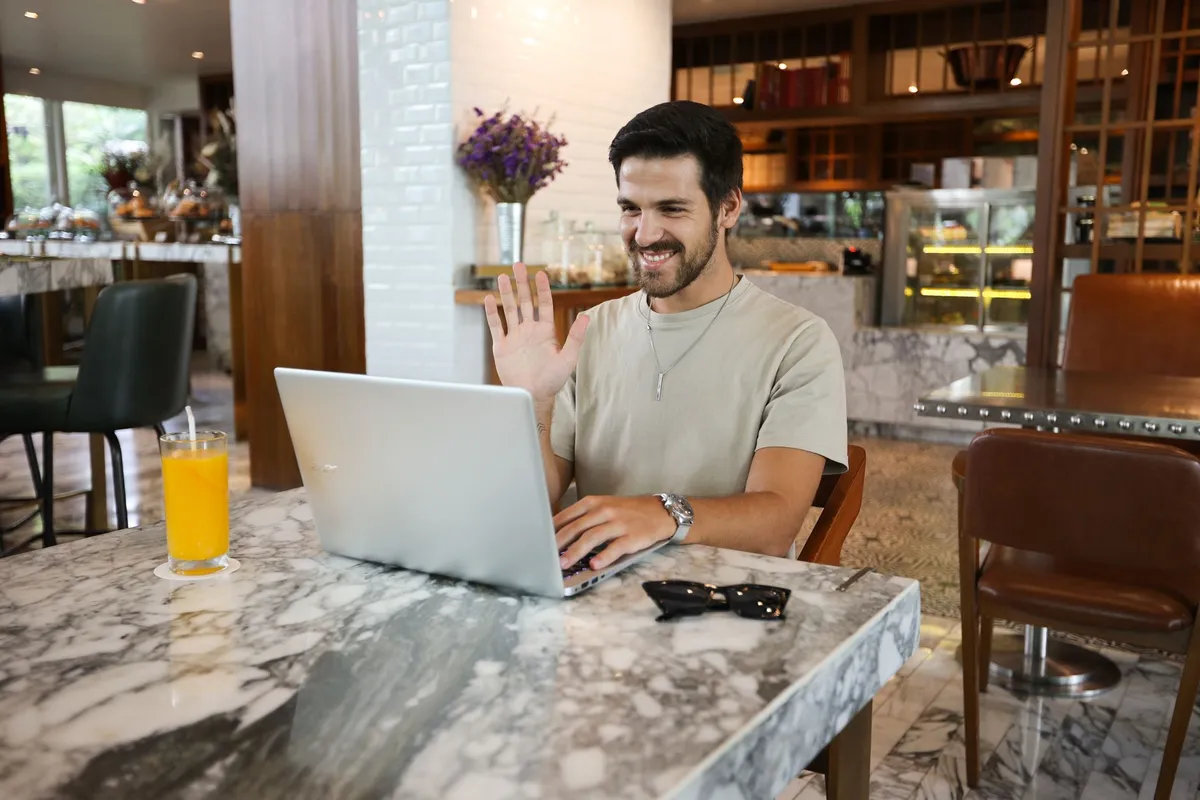 Image of a digital nomad working on a laptop in a café