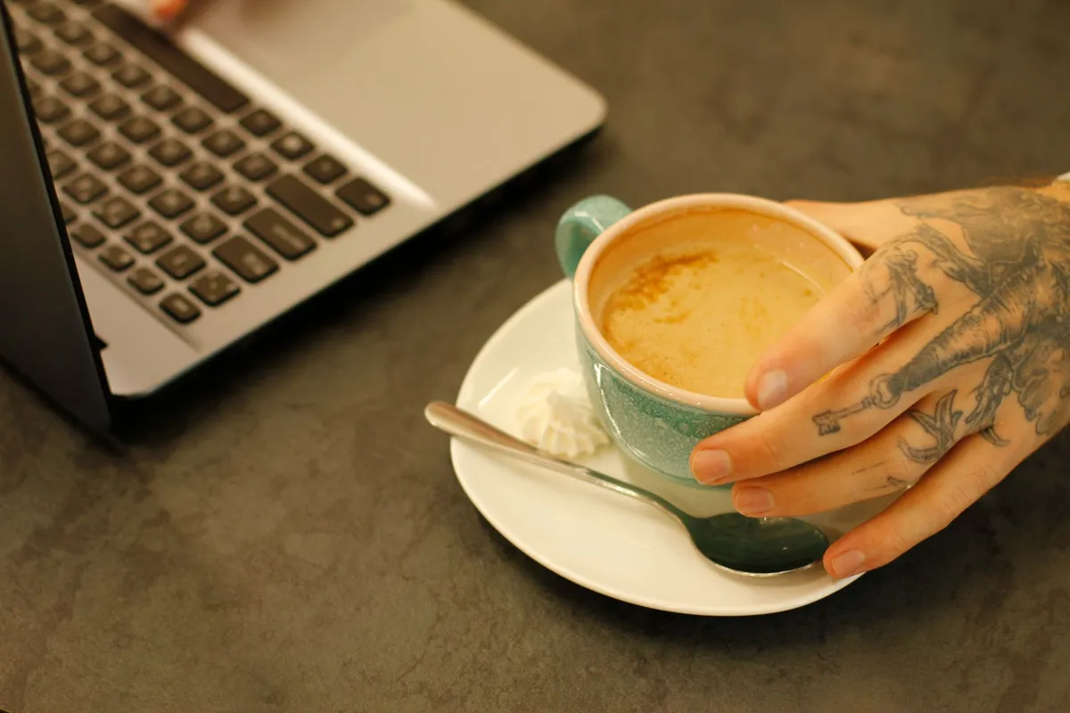 Cozy café in Bologna with laptop and espresso