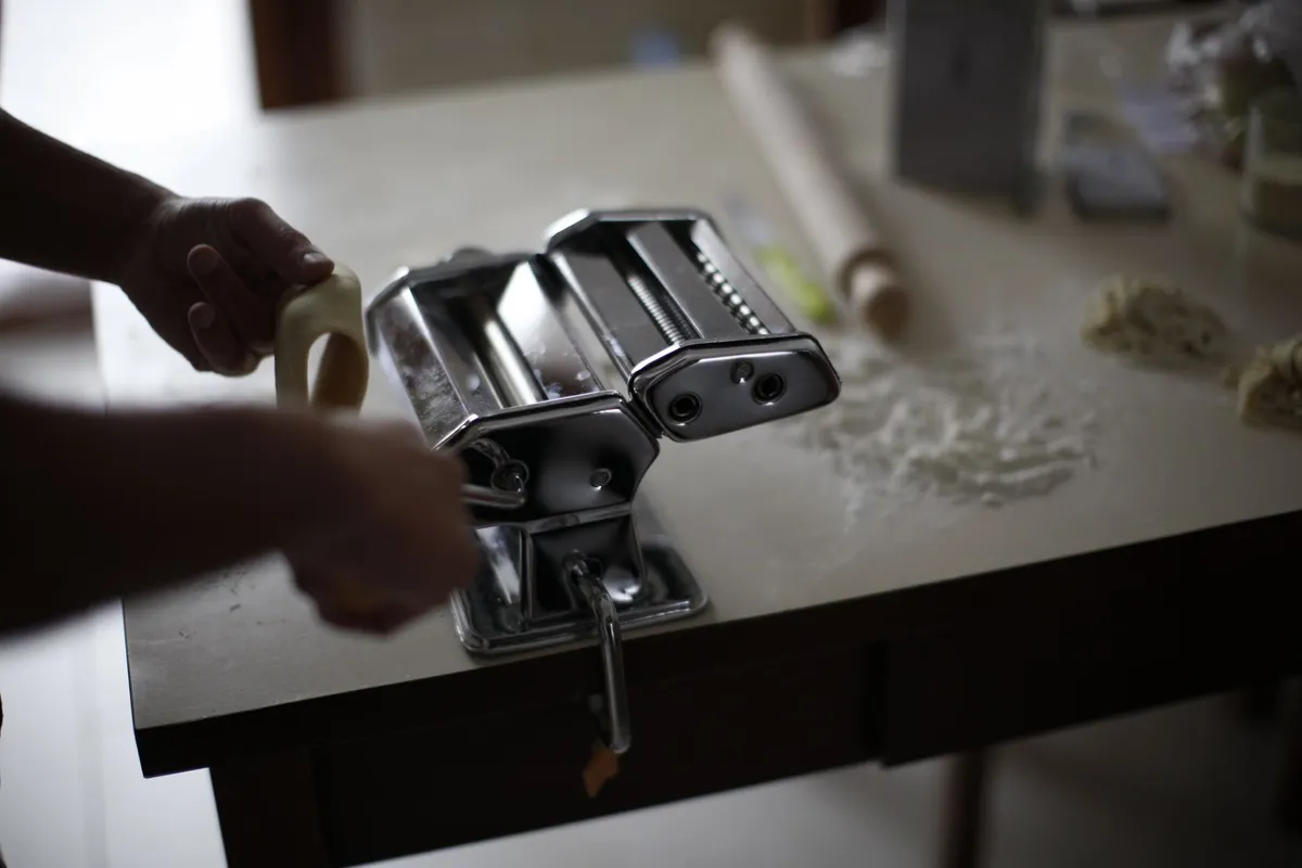 Fresh pasta being rolled in a Roman kitchen