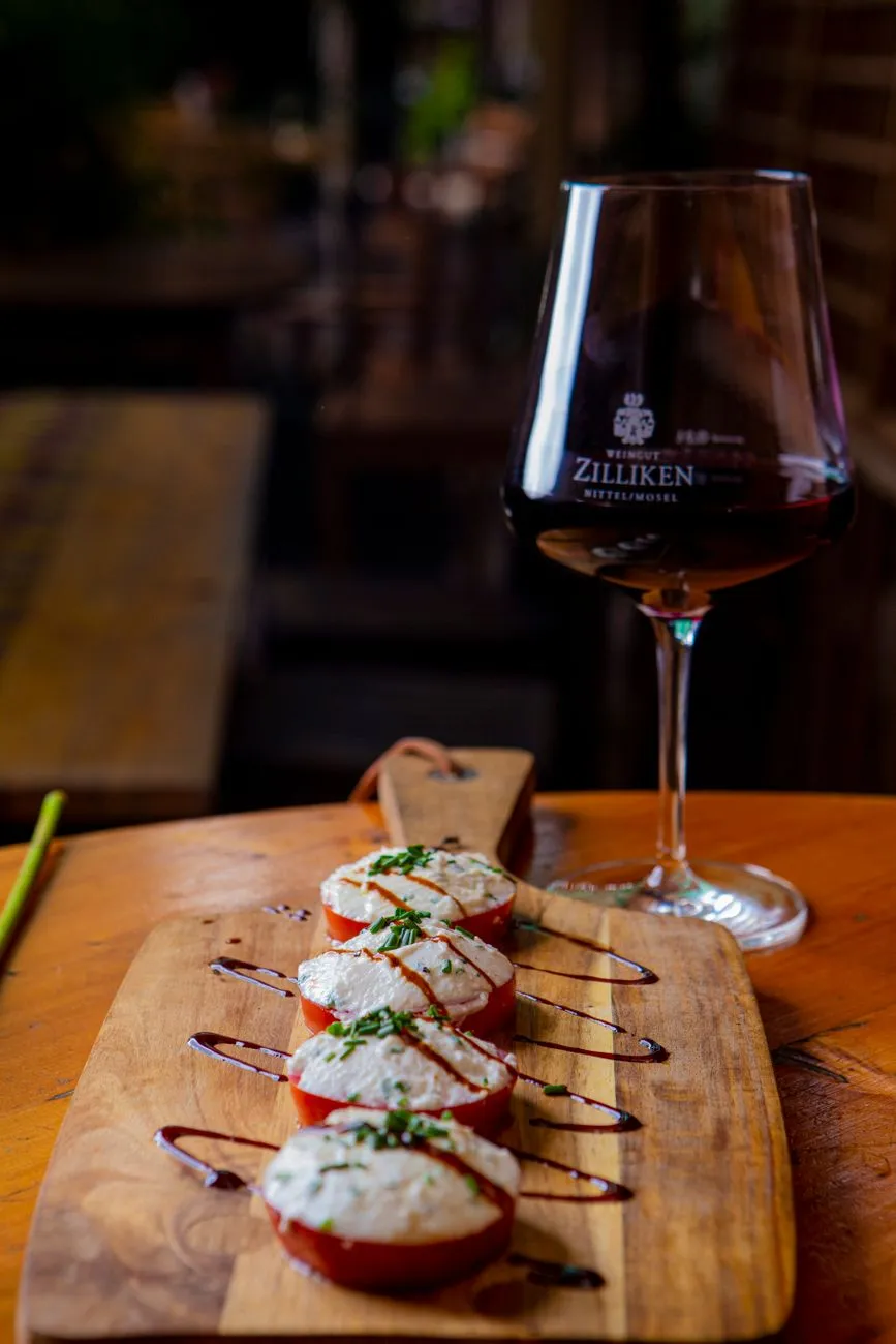 A glass of pale sherry next to a plate of fried seafood