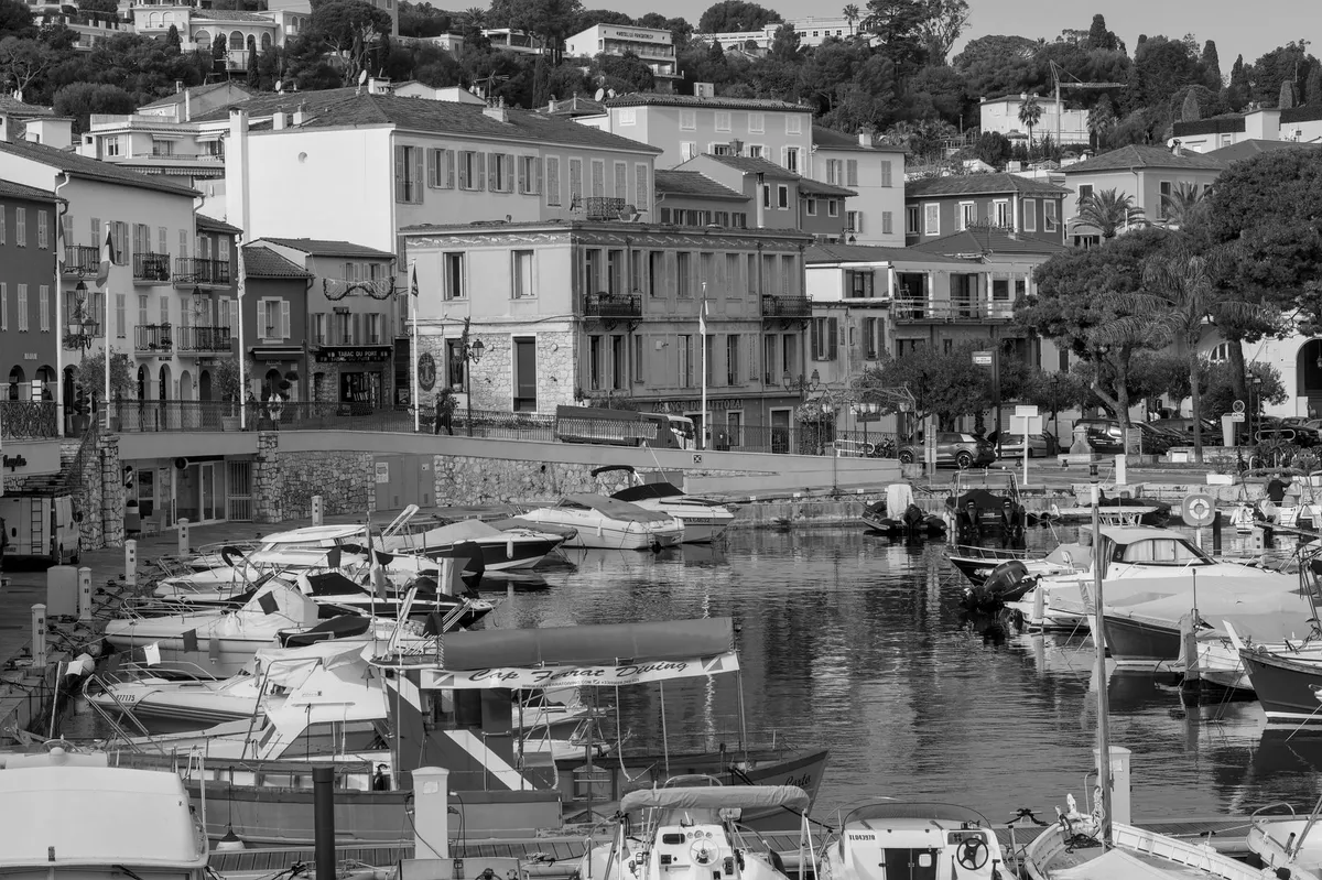 French Riviera coastal road with pastel villages and yachts in the harbor