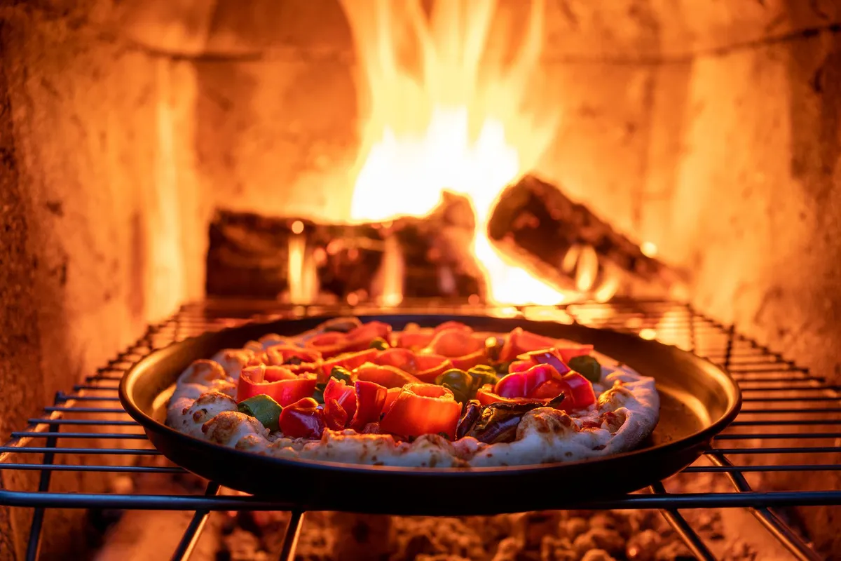 Neapolitan pizza baking in a wood-fired oven