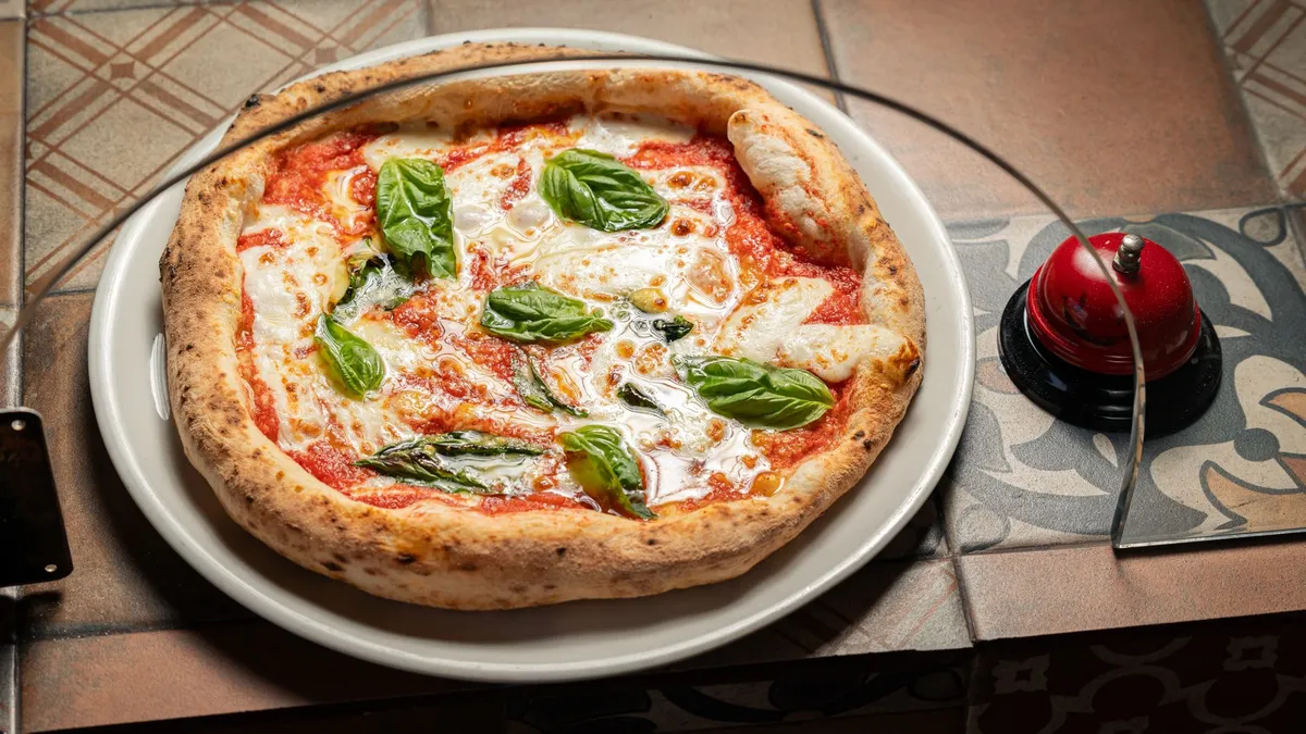 Homemade Neapolitan pizza with basil and mozzarella