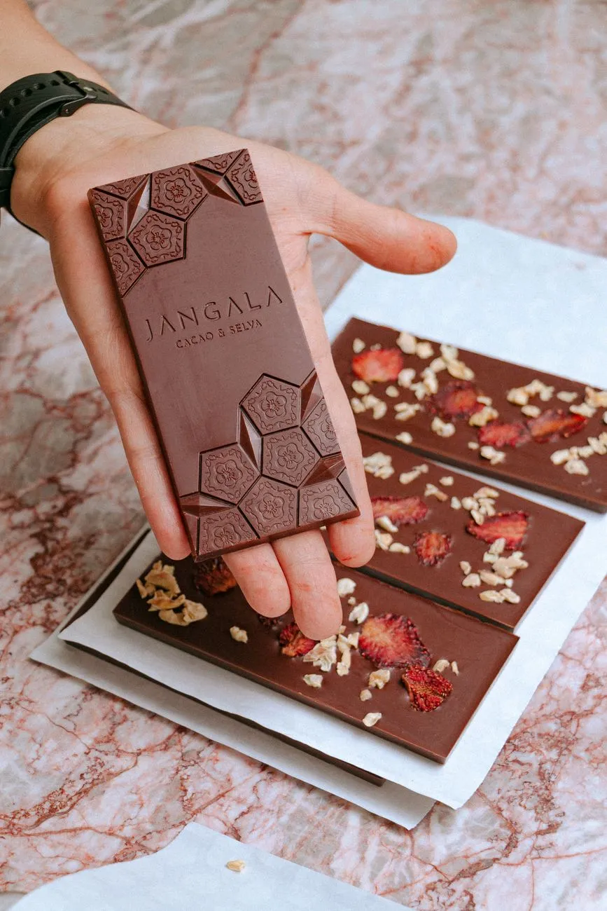 A collage of artisanal chocolate bars from different regions, each with distinct packaging and textures