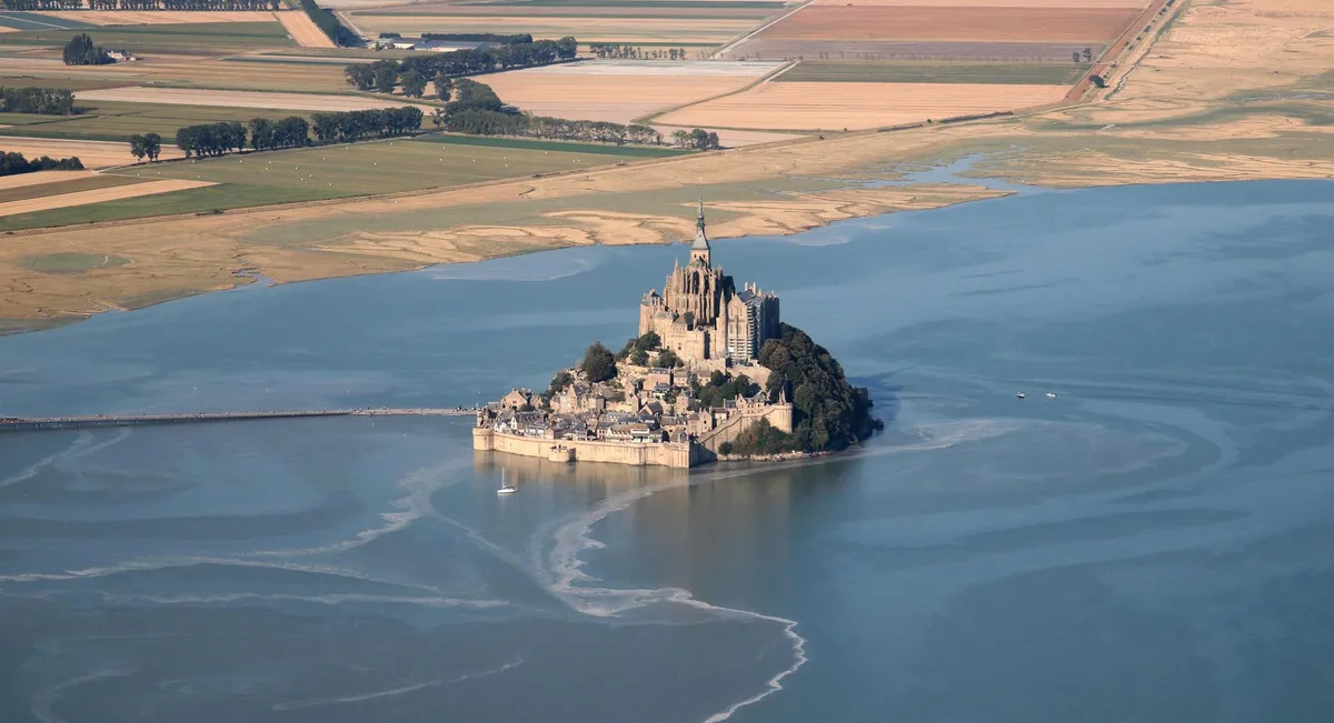 The historic abbey spire rising above the bay at high tide