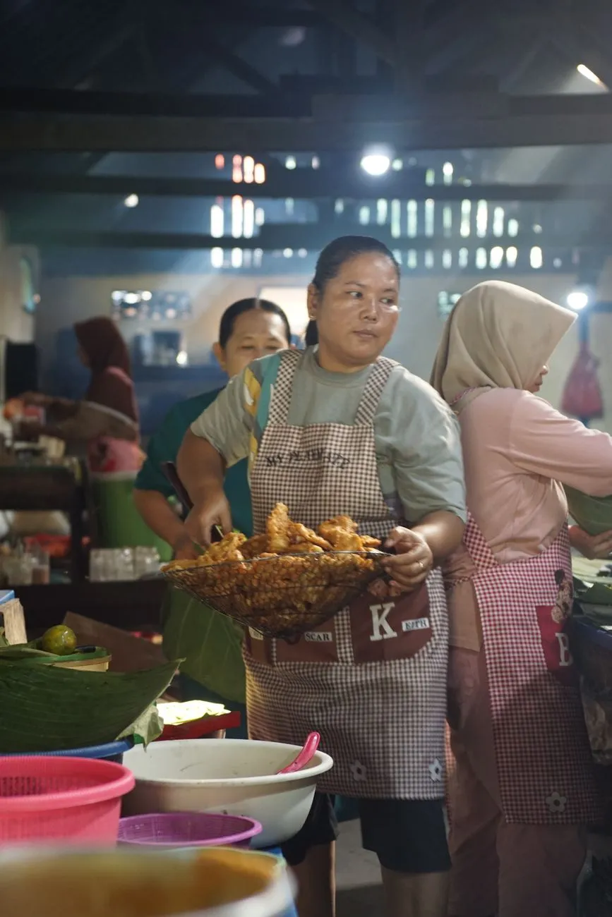 Street vendor cooking on a hot iron plate