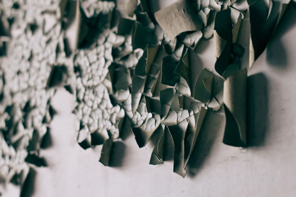 Dilapidated wall with paper scraps
