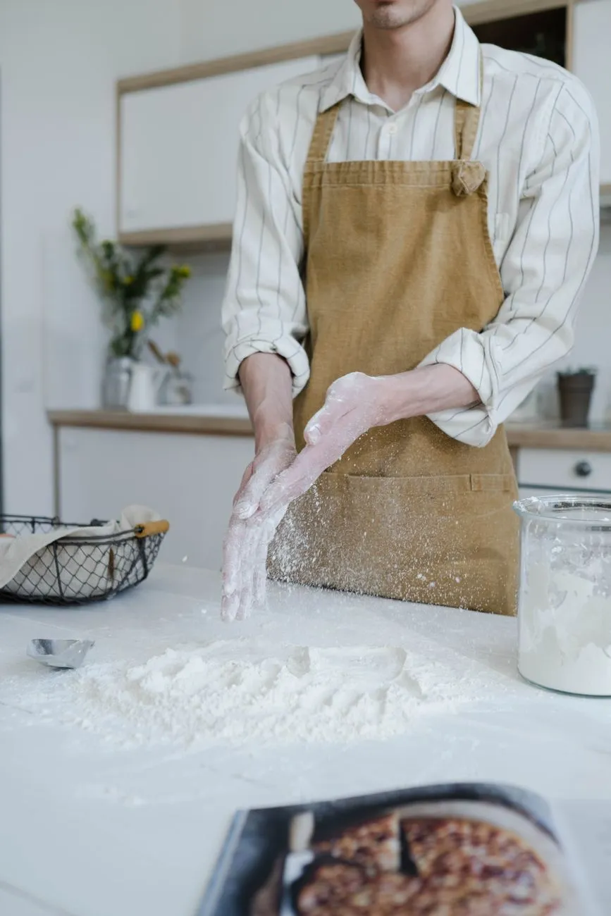 Baker stretching and folding dough