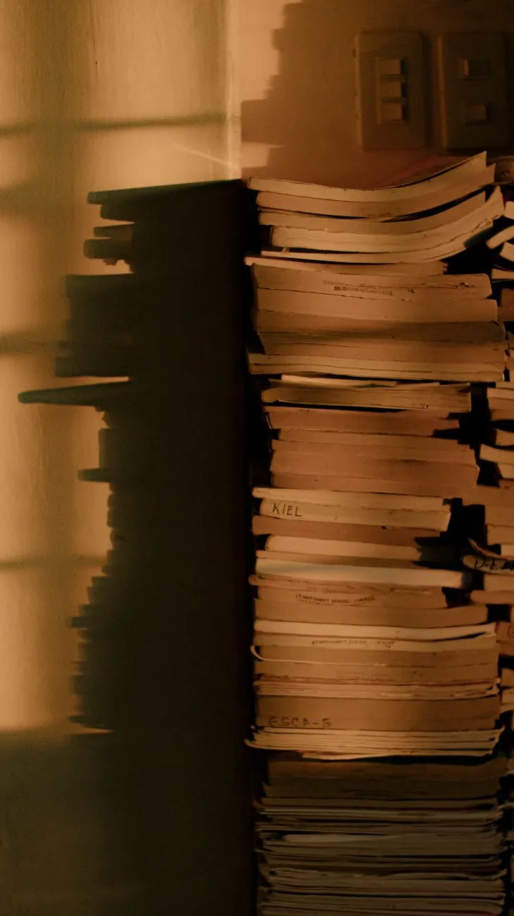 Books piled up in a dark room