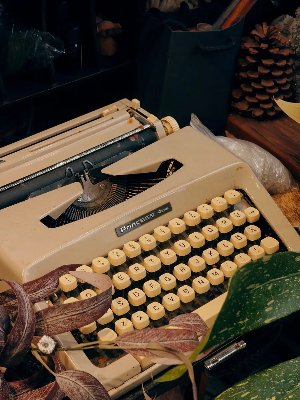 A vintage typewriter with old papers on a wooden desk