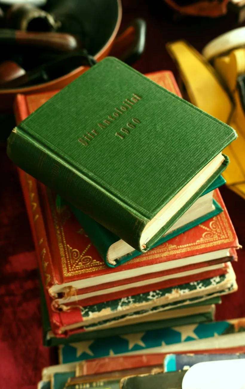 Old books stacked in a dark dusty cellar