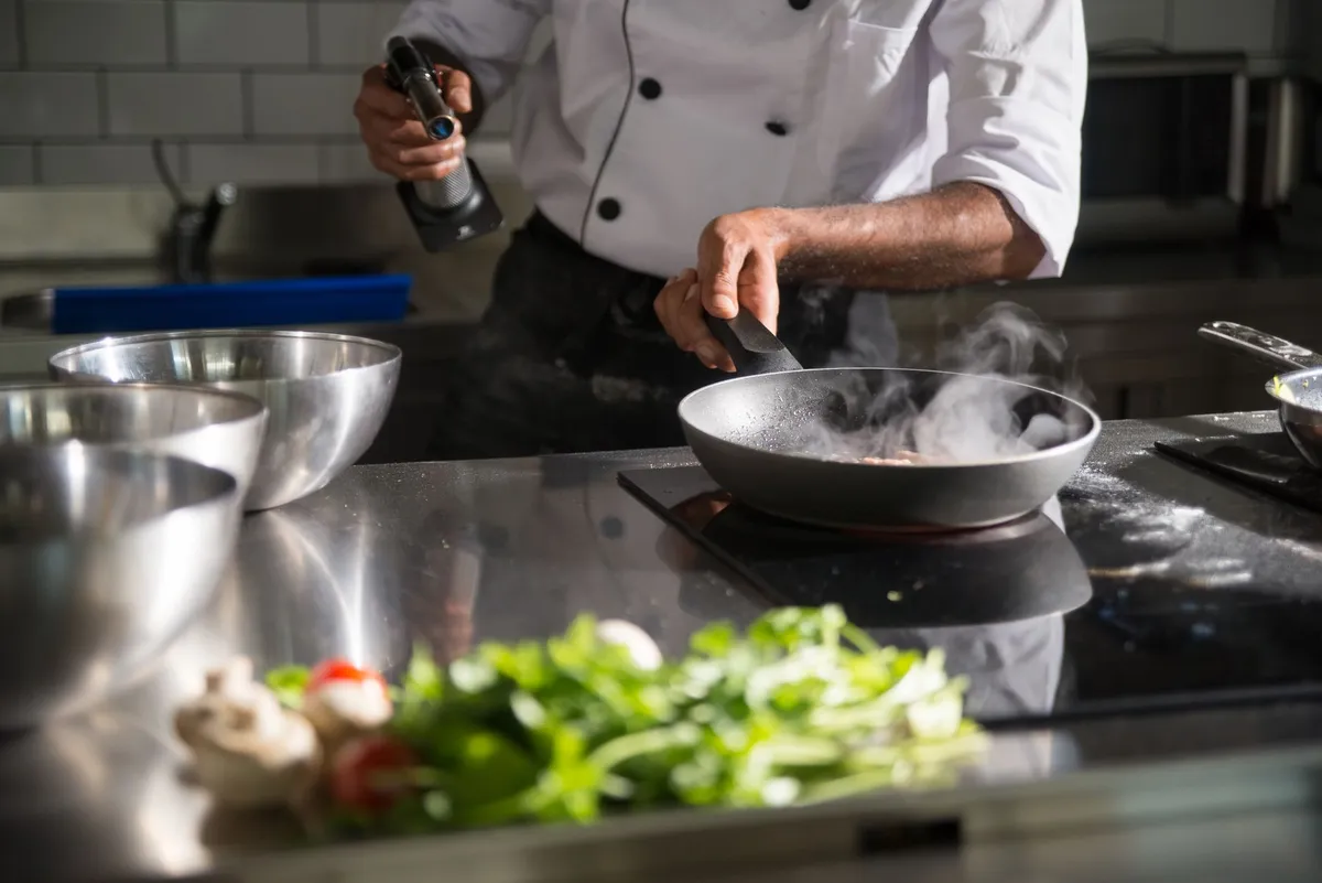 Master chef garnishing authentic biryani