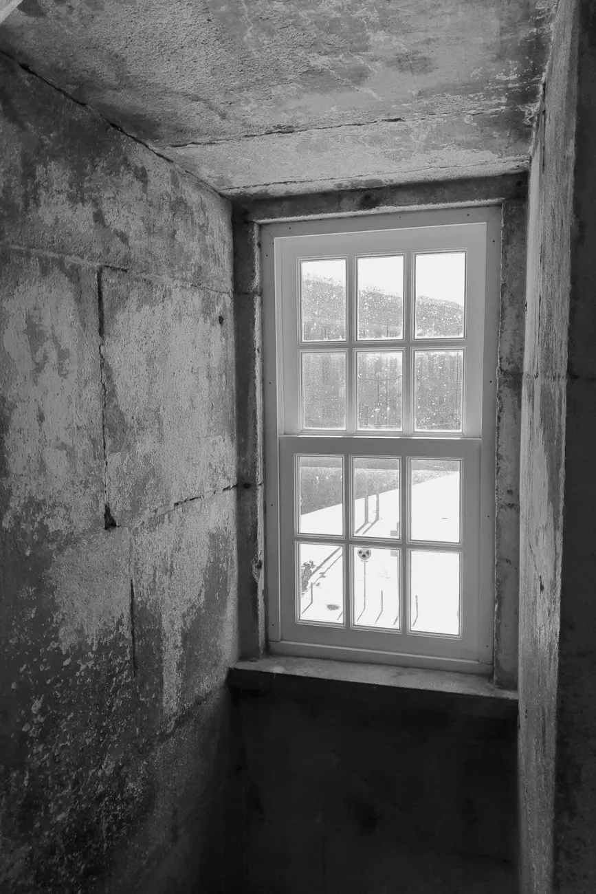 Lonely nomad looking out window at city