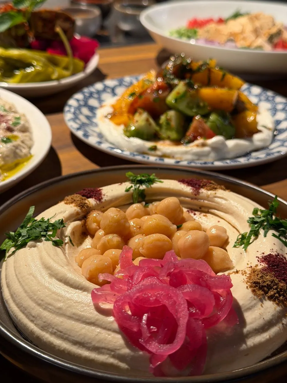 A colorful mezze spread with hummus, falafel, and pickled vegetables