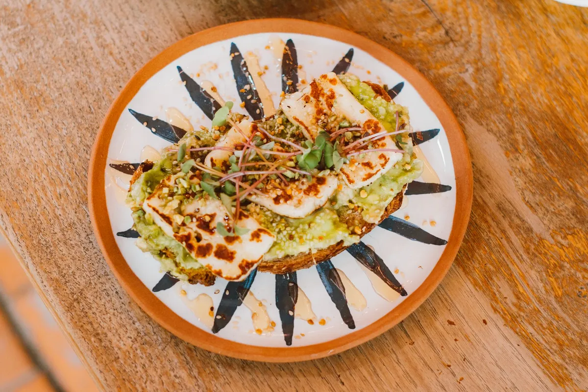 A plate of grilled halloumi with za'atar and pomegranate seeds