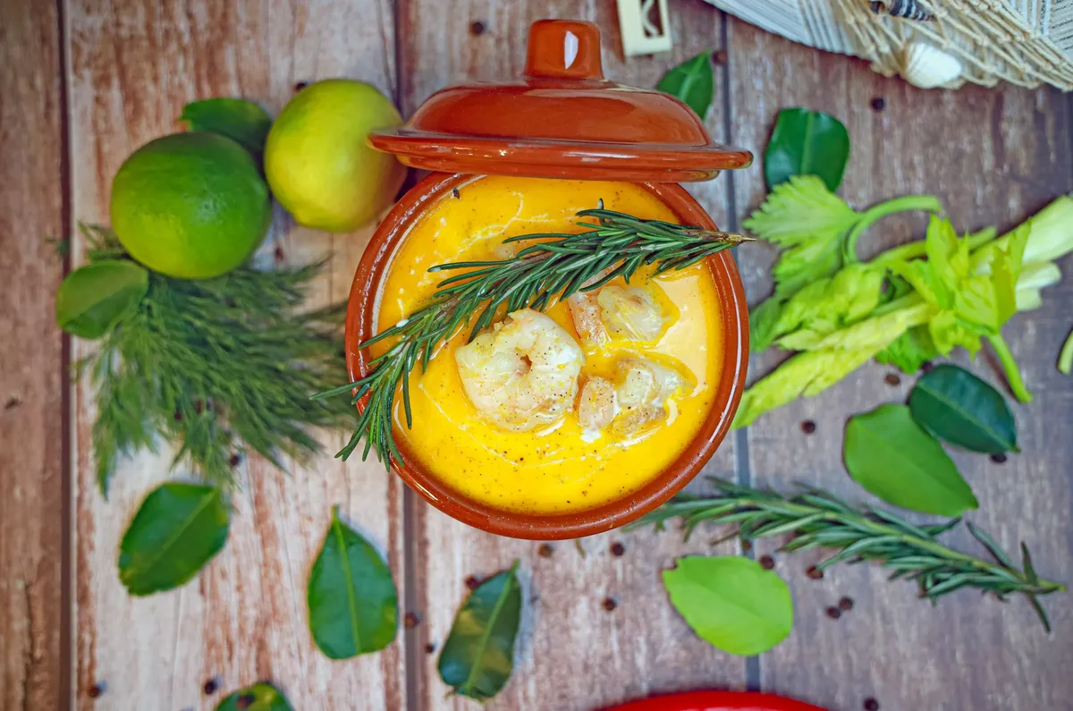 A vibrant bowl of Malaysian Laksa with prawns and herbs