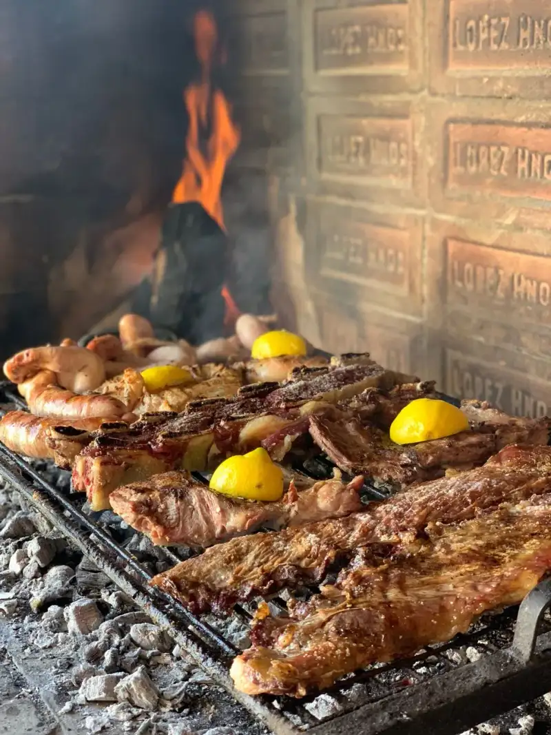 Modern asado setup with hybrid grill