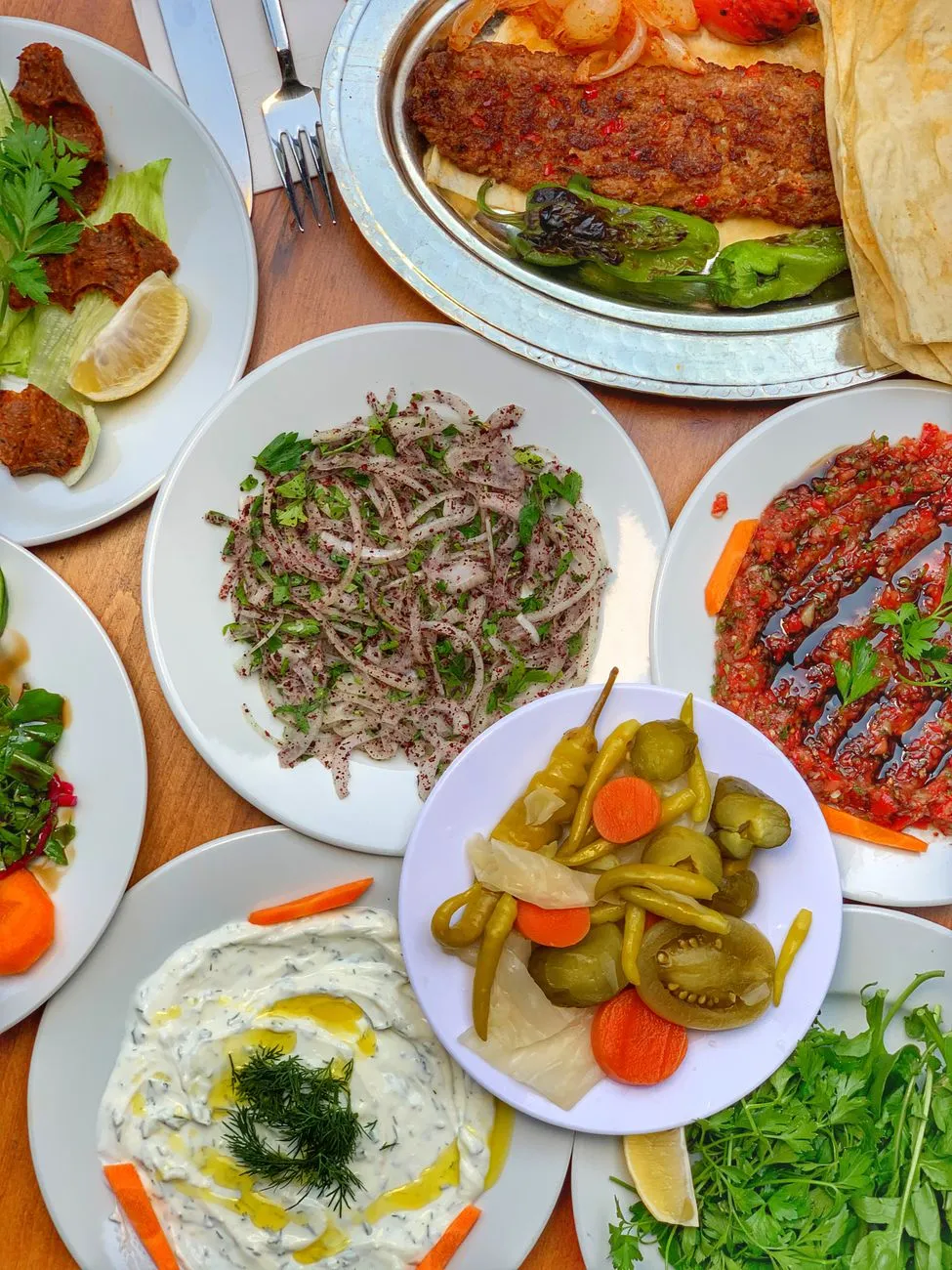 A mezze platter with grilled kebabs and fresh vegetables