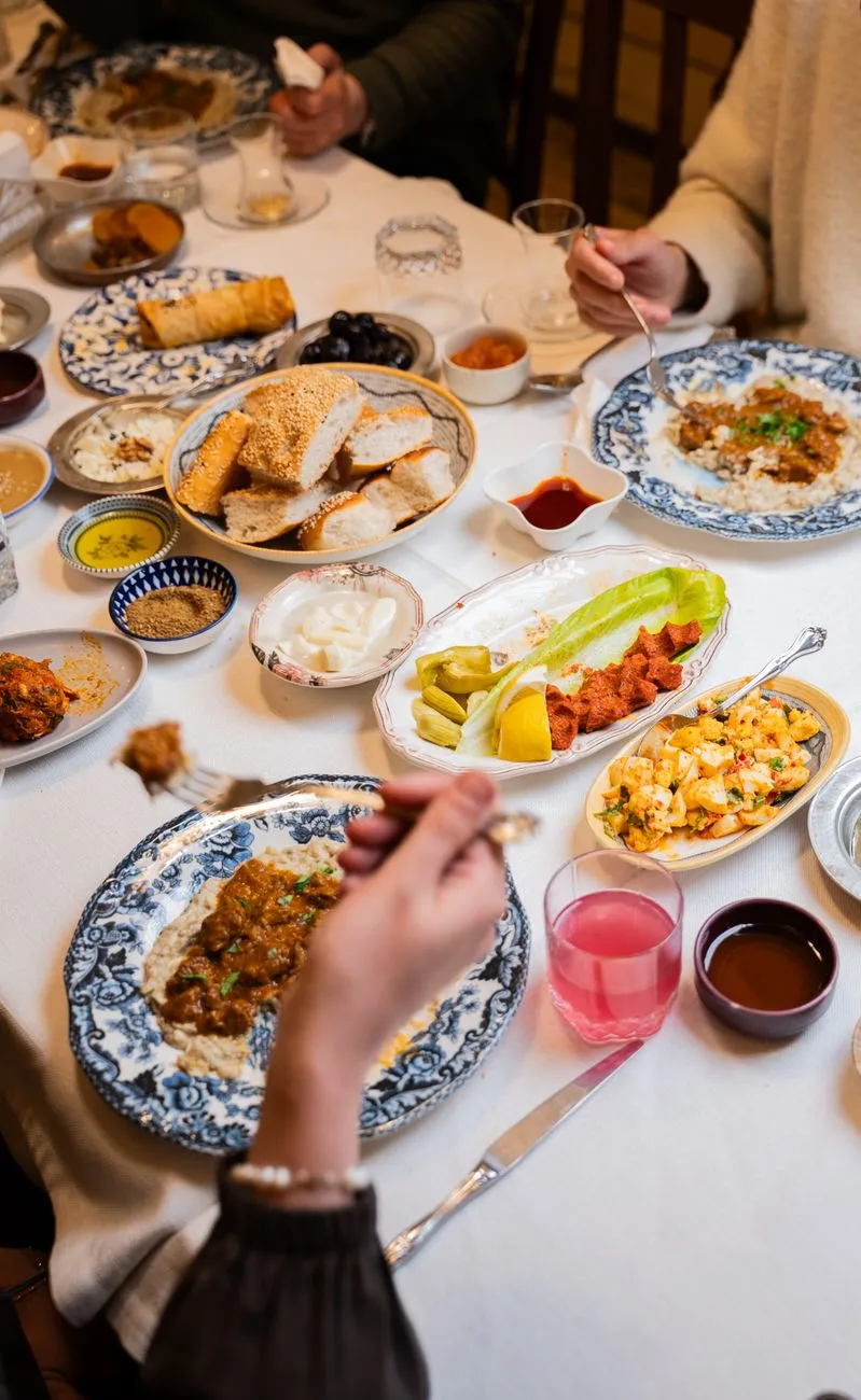 A family gathered around a mezze table