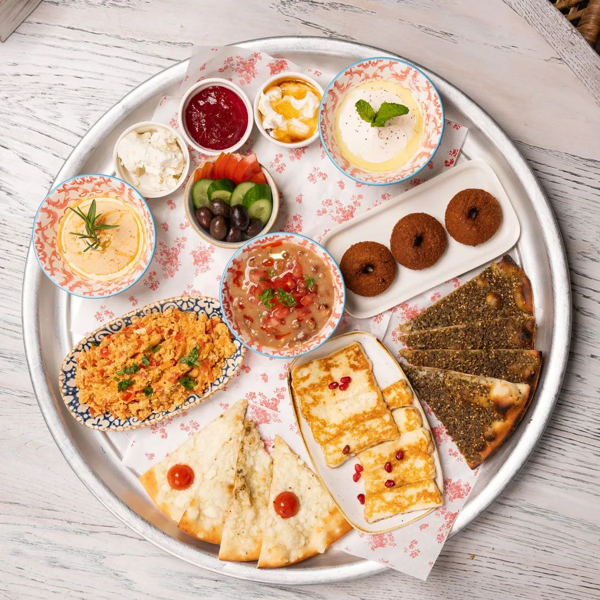 A mezze spread with falafel, hummus, and pita