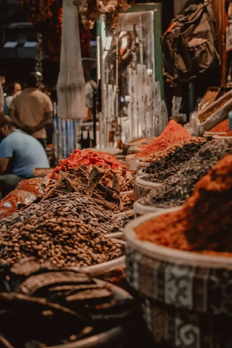A bustling Syrian souk with vendors selling spices and dried goods