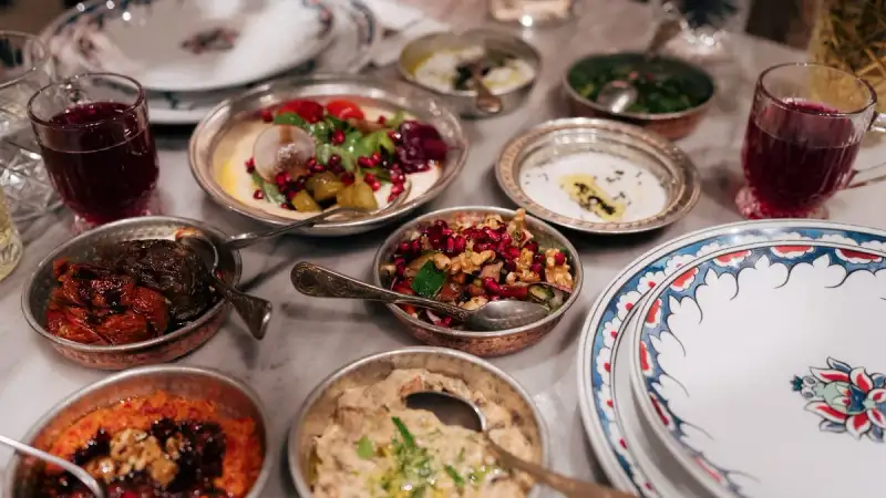 A Syrian mezze spread with muhammara, kibbeh, and fattayer